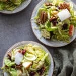 Shaved Brussel Sprouts Salad with Maple Dressing on white plates.