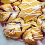 Cranberry Orange Brioche Star Bread with glaze on the top.