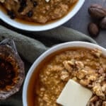 Instant Pot Pumpkin Spice Steel Cut Oats in white bowls topped with walnuts and butter.