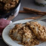 Vegan pear crumble on a white plate.