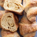 Whole wheat croissants on a surface.