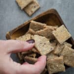 Woman grabbing a seed cracker.