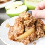 Apple crisp without oats on a white plate.