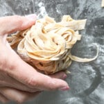 Woman holding whole wheat pasta.