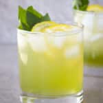 2 glass of basil lemonade on a counter.