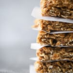 Banana oatmeal bars stacked with parchment paper between them.