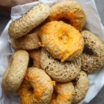Whole Wheat Bagels topped with cheese in a bowl.