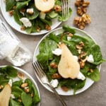 Poached pears on a spinach salad with candied walnuts and goat cheese.