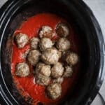 Baked gluten-free meatballs in marinara sauce in a crockpot.