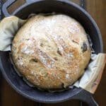 Green olive bread loaf in a cast iron.