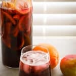 Non alcoholic sangria drink on a surface with a window in the background.