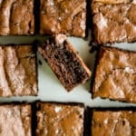 Rye brownies on a cutting board with salted tops.