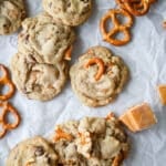 Chocolate chip caramel pretzel cookies stacked on a surface.