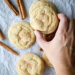 Women holding a snickerdoodle cookie.