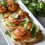 Shrimp avocado crostinis on a white tray