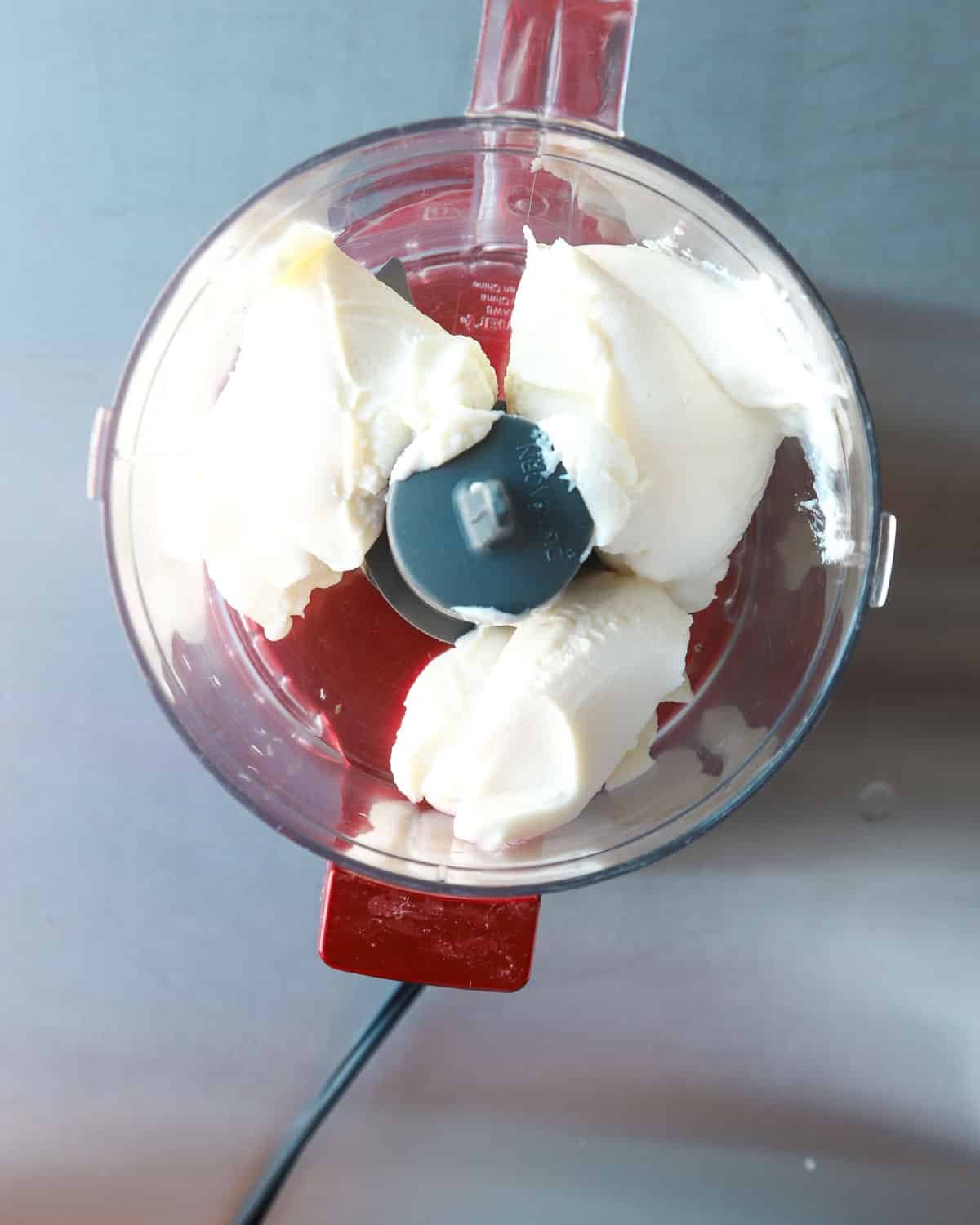 Ricotta in a small red food processor.