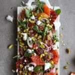 Blood orange salad on a white rectangle platter.