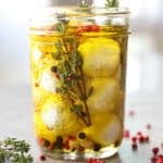 Marinated goat cheese in a mason jar with spices.