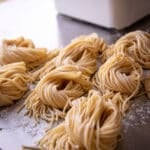 Extruded pasta in front of a Philips pasta machine.