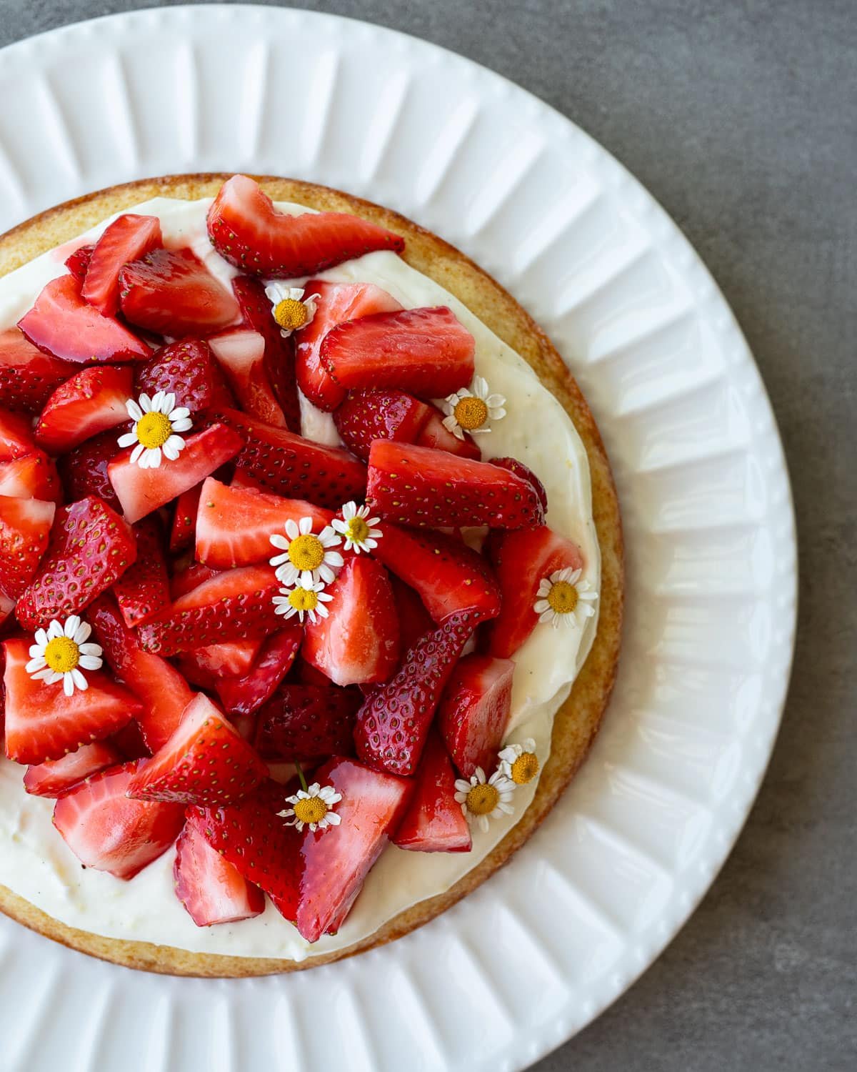 Strawberry chamomile cake on a white plate.