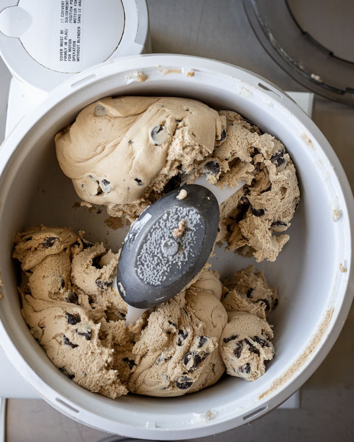 Chocolate chip cookie batter in a Bosch mixer.