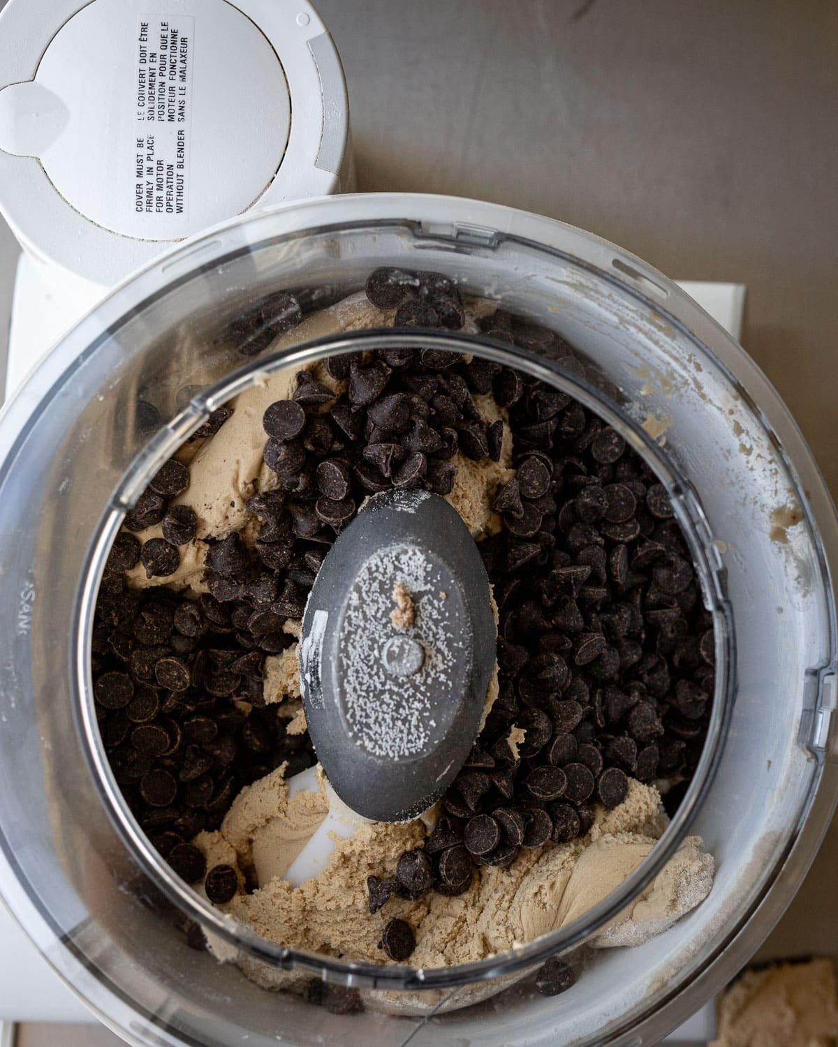 Chocolate chip cookie batter in a Bosch mixer.