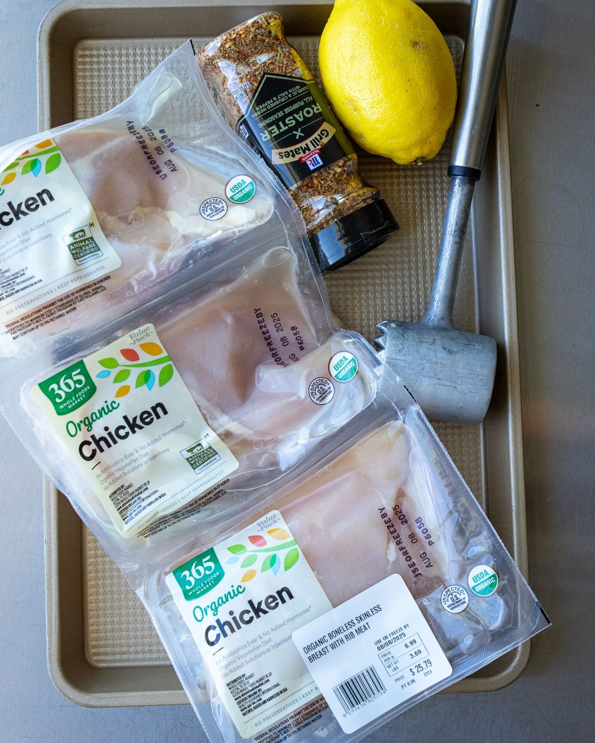 Ingredients for grilled chicken on a metal tray.