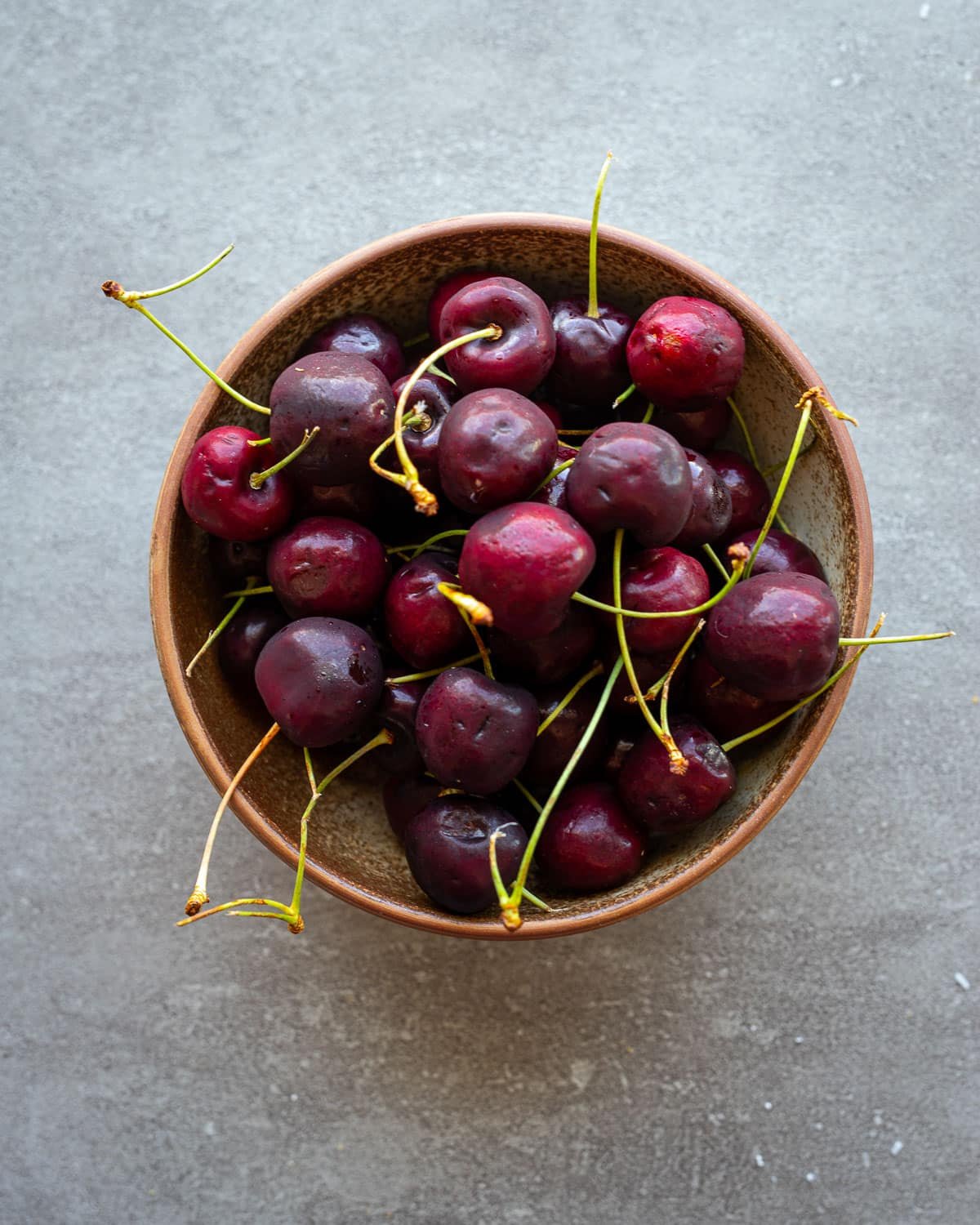Fresh cherries in a ceramic bowl. 