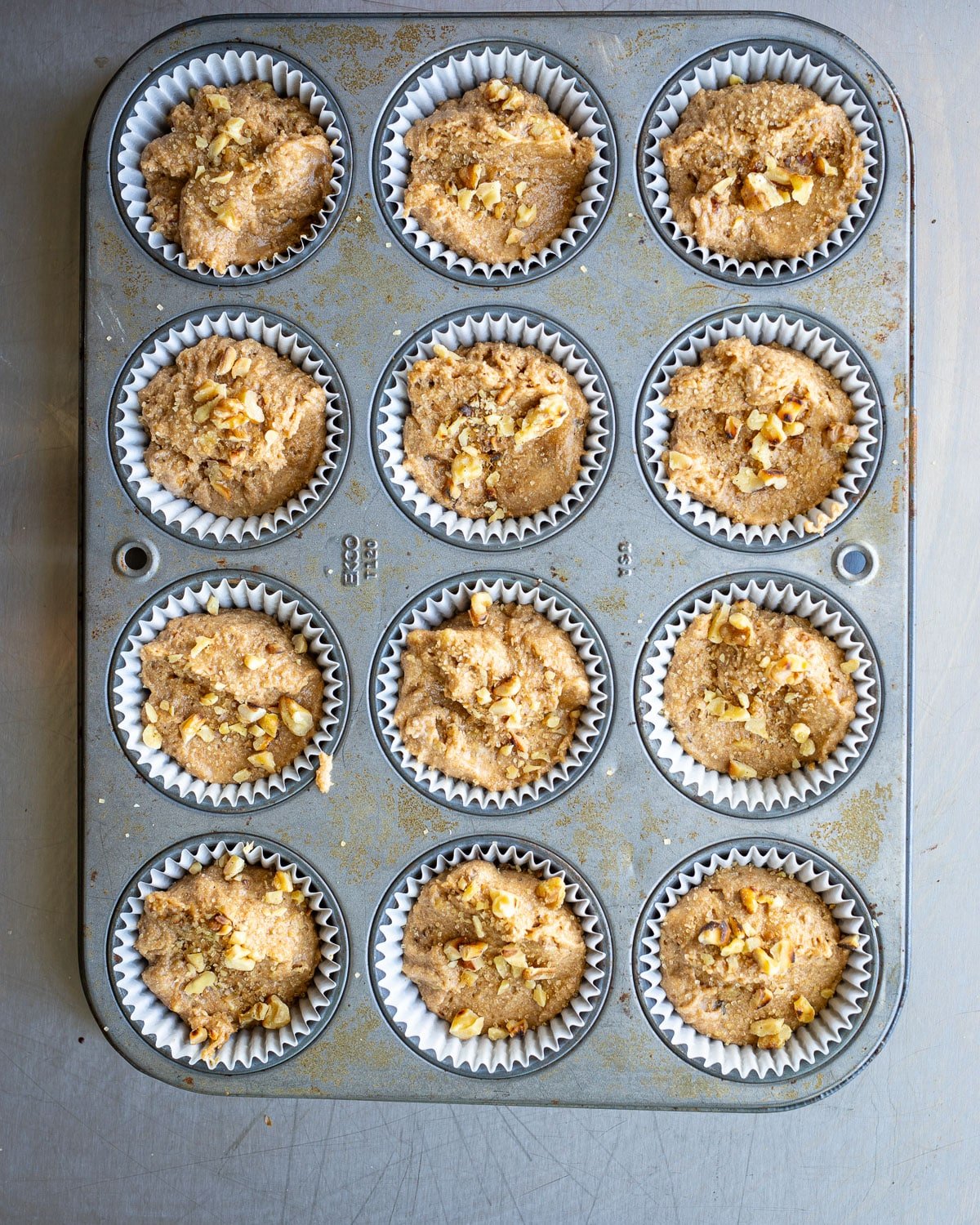 Muffin batter in a muffin pan ready for baking. 
