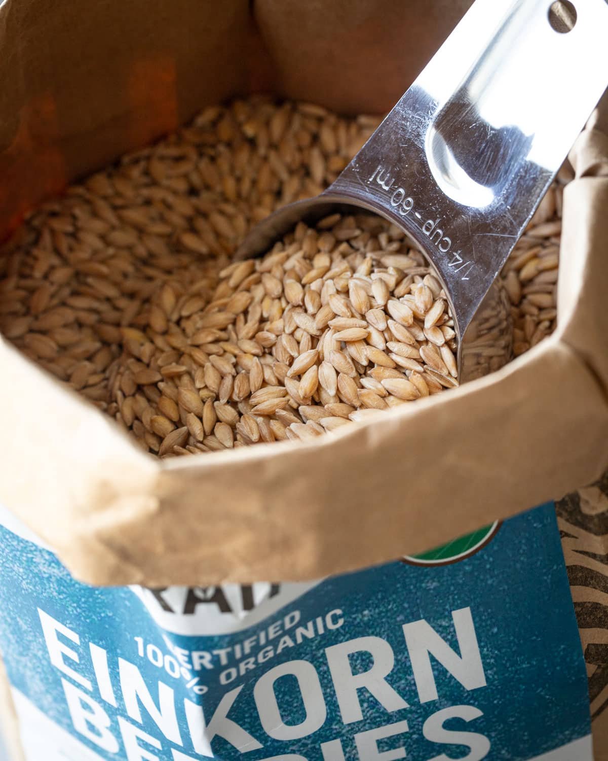Bag of einkorn flour with a measuring cup in it.